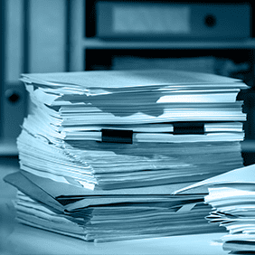 Stack of paperwork and documents, representing manual processing instead of mazaya board