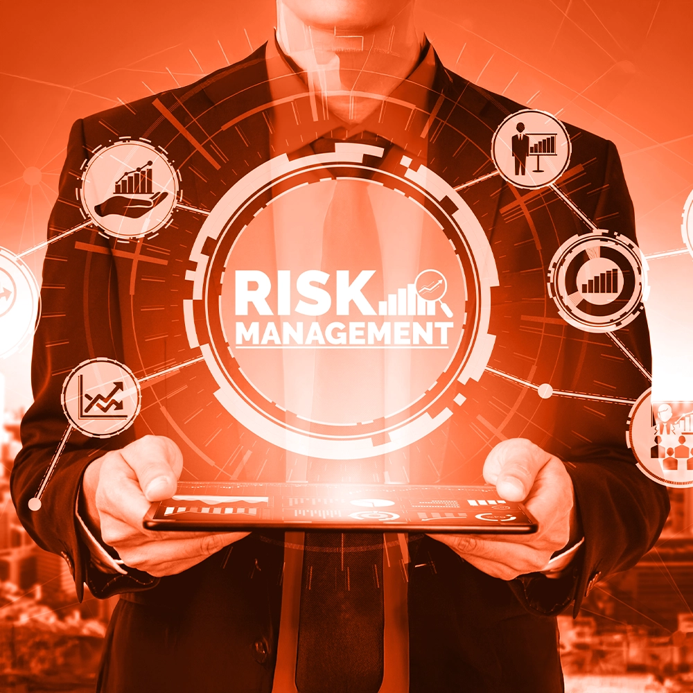Employee holding a tablet displaying a symbol or graphic labeled risk management.